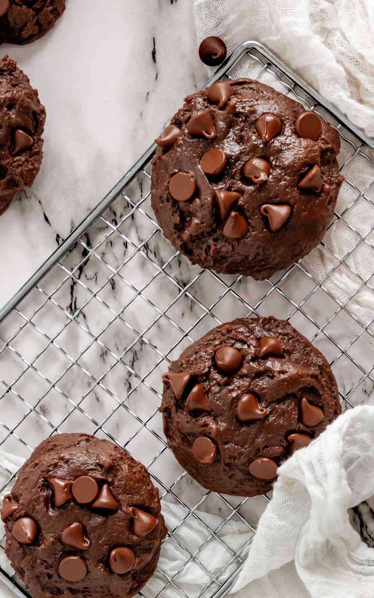 Birds eye view of double chocolate fudge cookies on a wire rack.