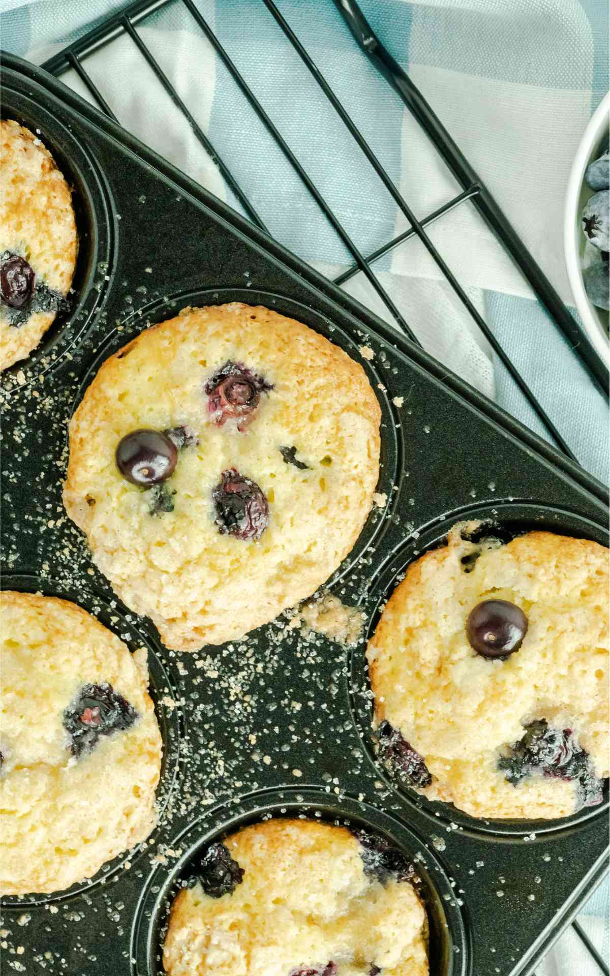 Close up of blueberry cake mix muffins on a wire rack.