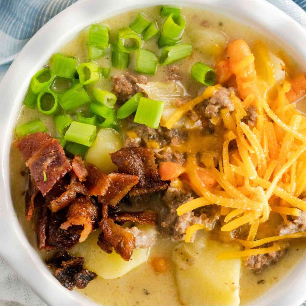 Closeup of a bowl of cheeseburger soup with bacon and cheese.