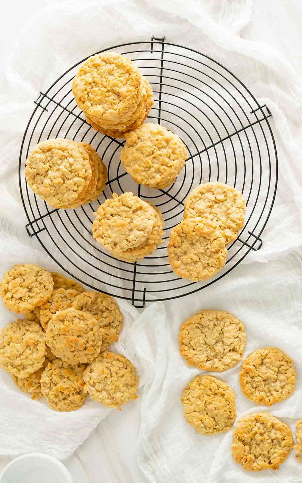 Overhead picture of stacks of piles of old fashioned cracker jack cookies on a cooling rack.