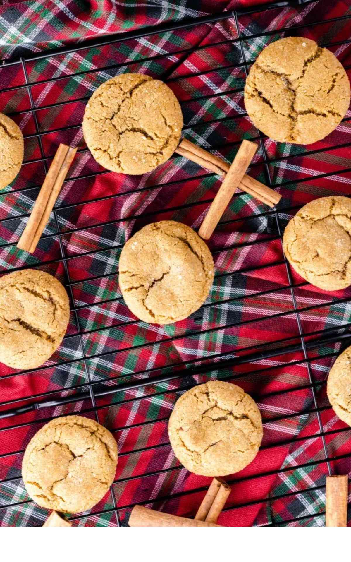 Soft chewy gingersnap cookies spaced out on a cookie rack.