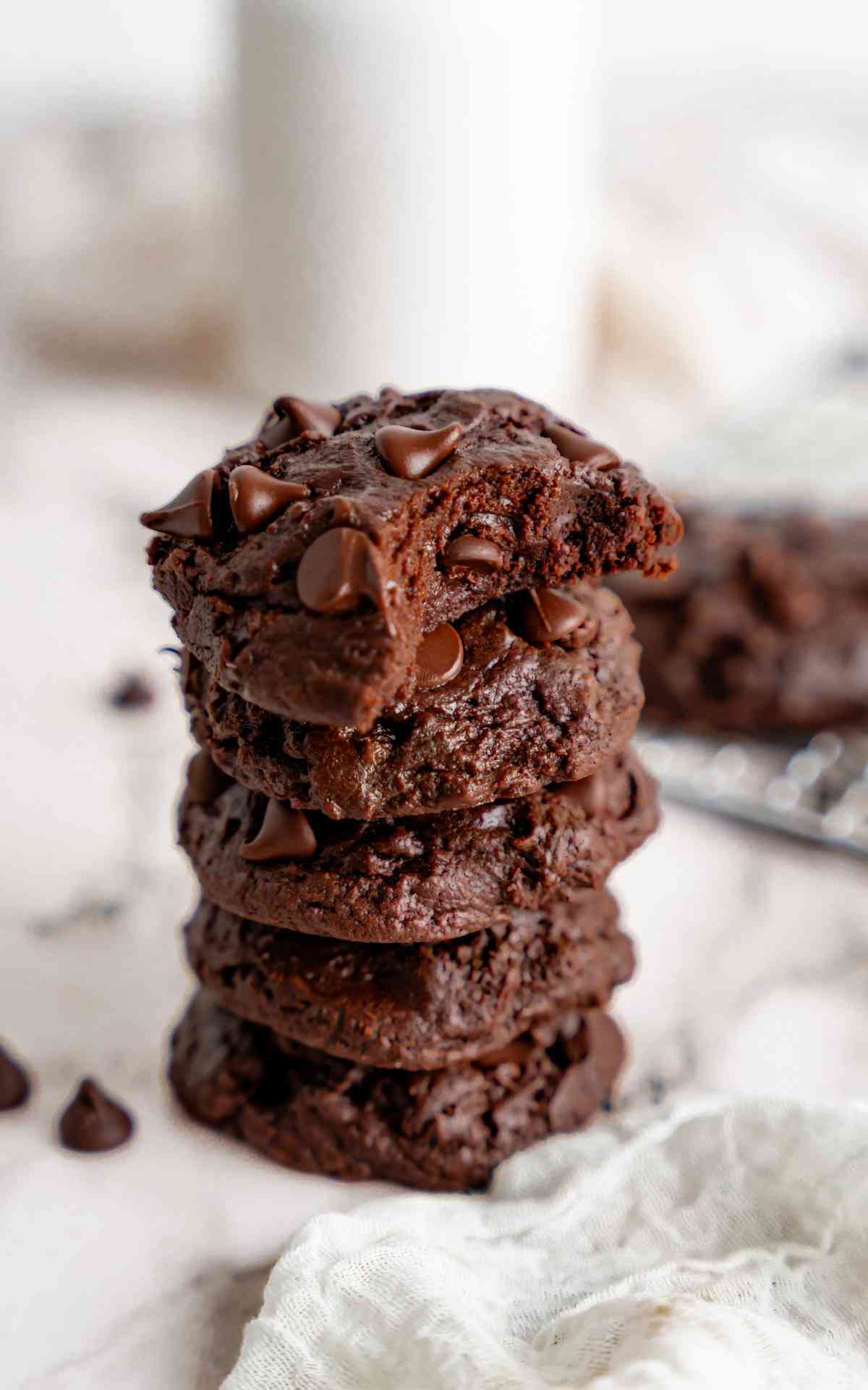 Stacked double chocolate fudge cookies with a bite taken.