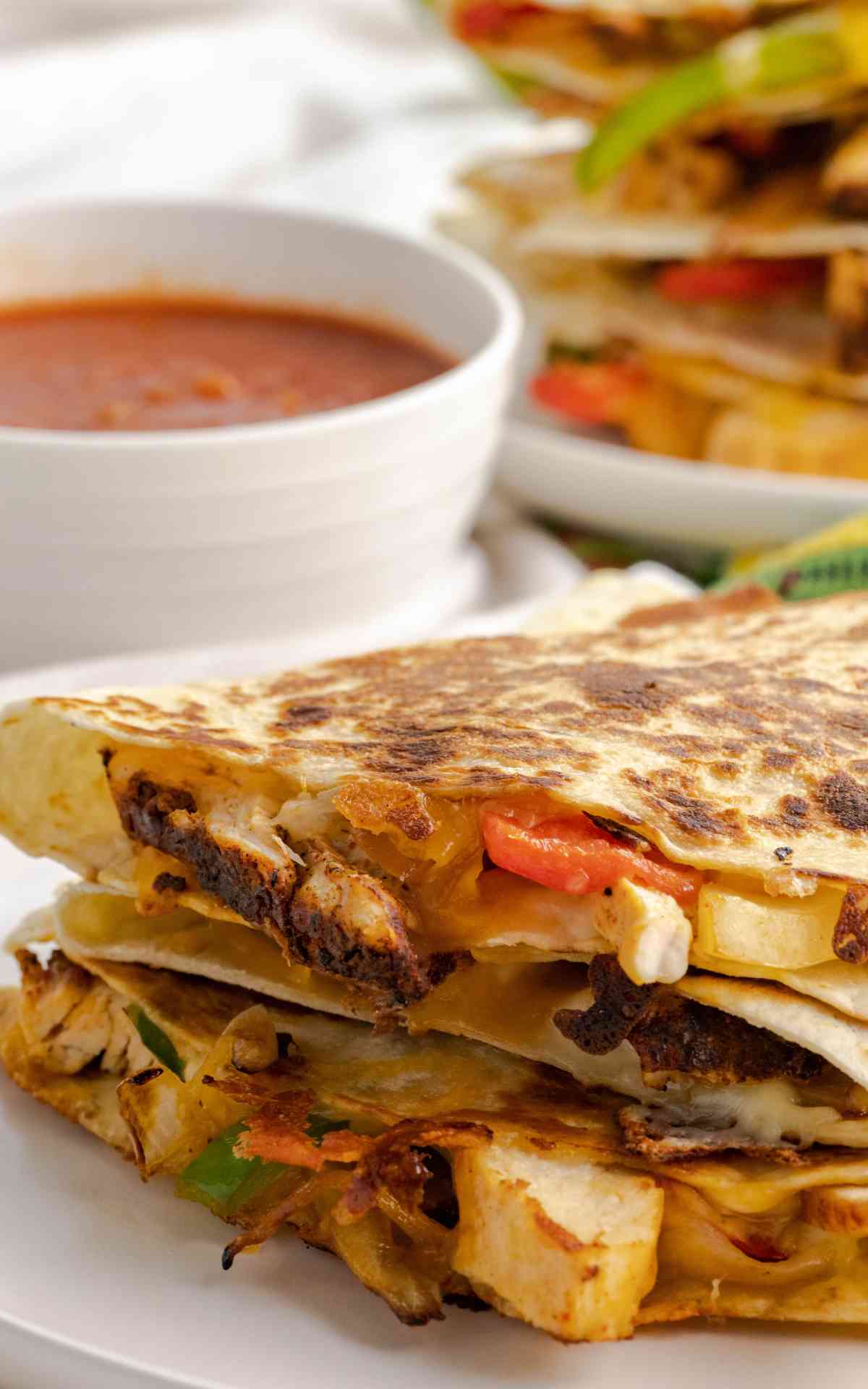 Two chicken fajita quesadillas with seasoned chicken and crisp peppers
