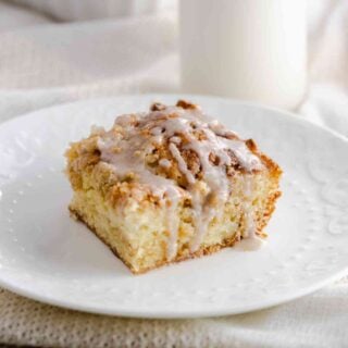 Apple Crumb Coffee Cake sliced and drizzled with vanilla icing.