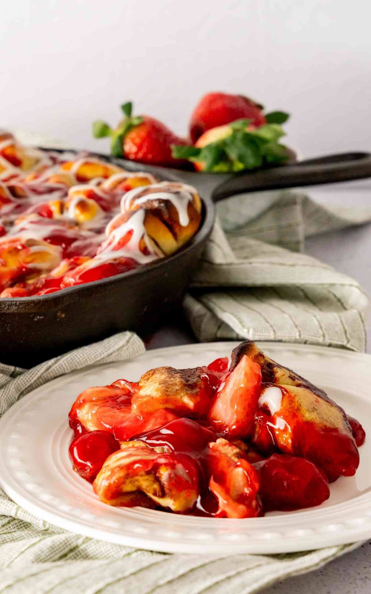 A serving of an easy version of strawberry cinnamon rolls on a plate.