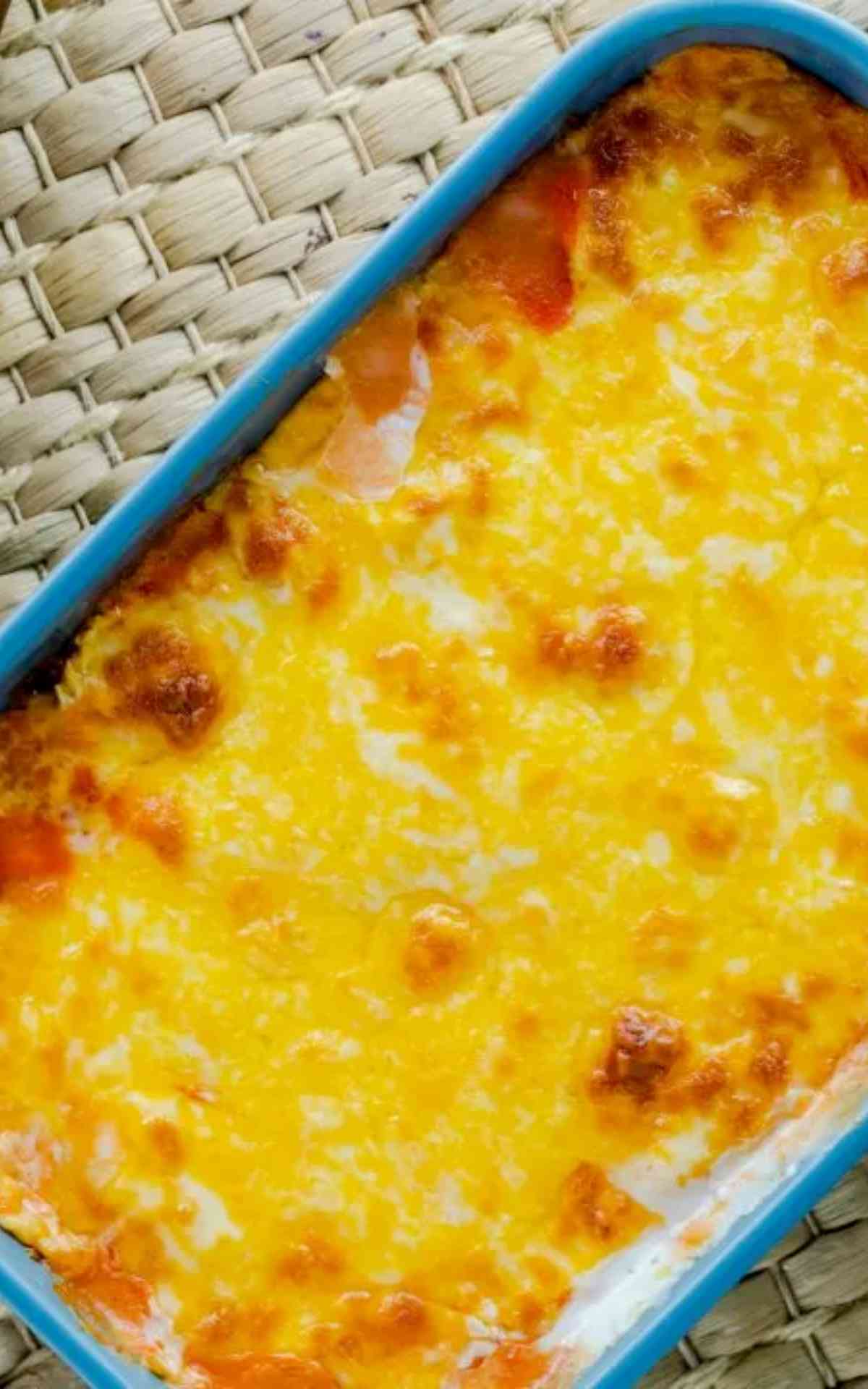 An overhead picture casserole dish with hot cheesy buffalo chicken dip.