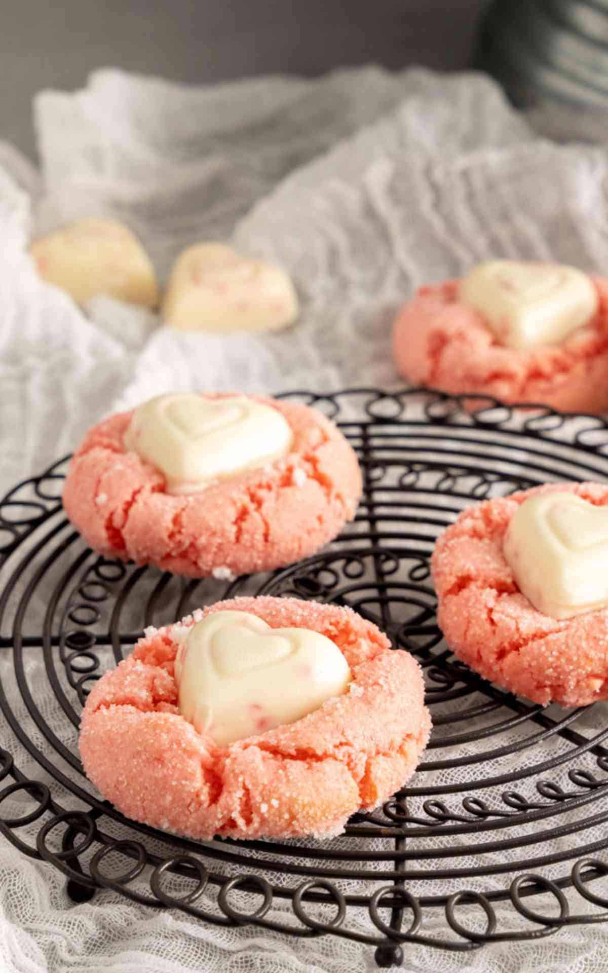 Three cake mix cookies with white chocolate hearts in the center.