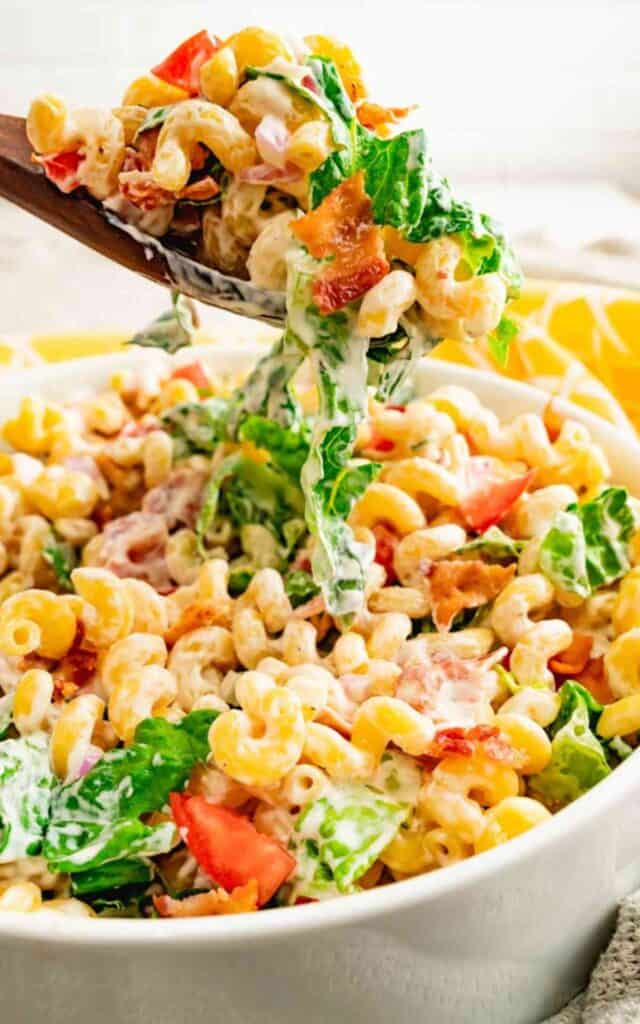 A large scoop of BLT pasta salad with crispy bacon and romaine lettuce.
