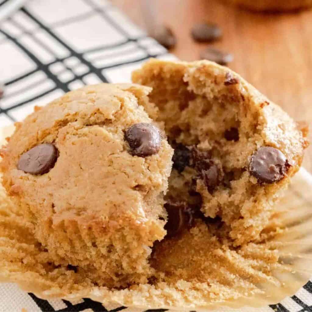 A cappuccino muffin cut in half with hot melted chocolate chips.