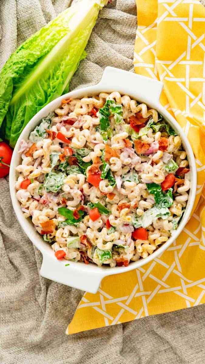 Overhead view of a casserole dish of a freshly made BLT pasta salad recipe.