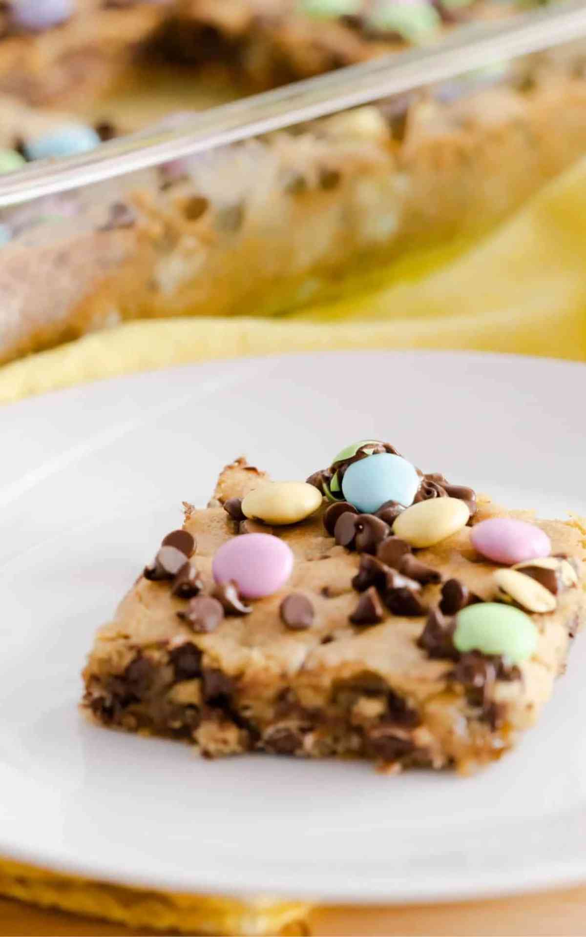 A Chocolate Chip Cookie Bar topped with M&Ms.