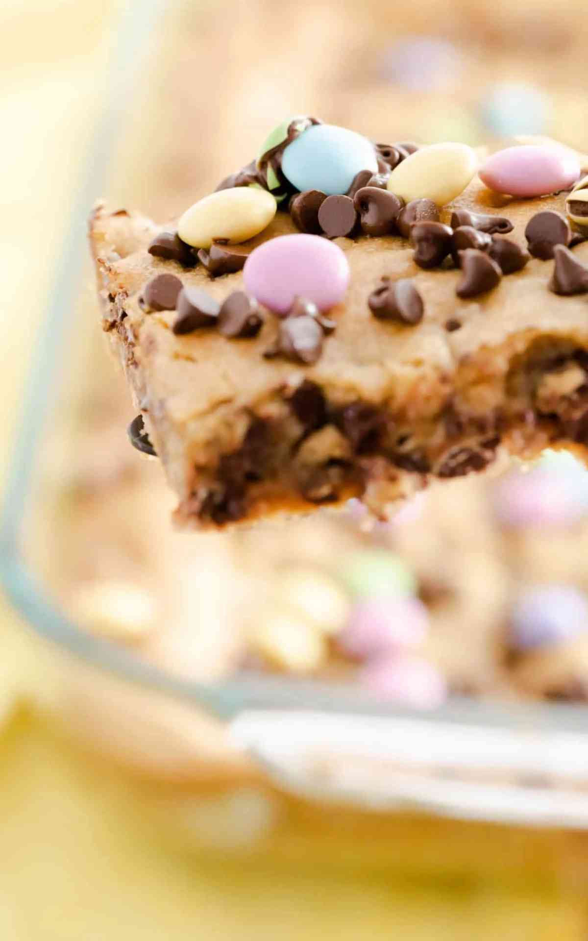 A Chocolate Chip Cookie Bar with pastel M&Ms.