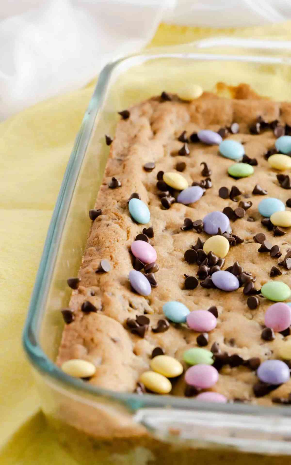 A glass pan of uncut Chocolate Chip Cookie Bars.