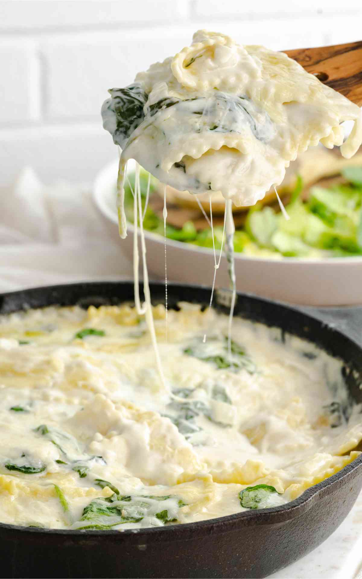 A slice of cheese spinach ravioli with melted cheese.