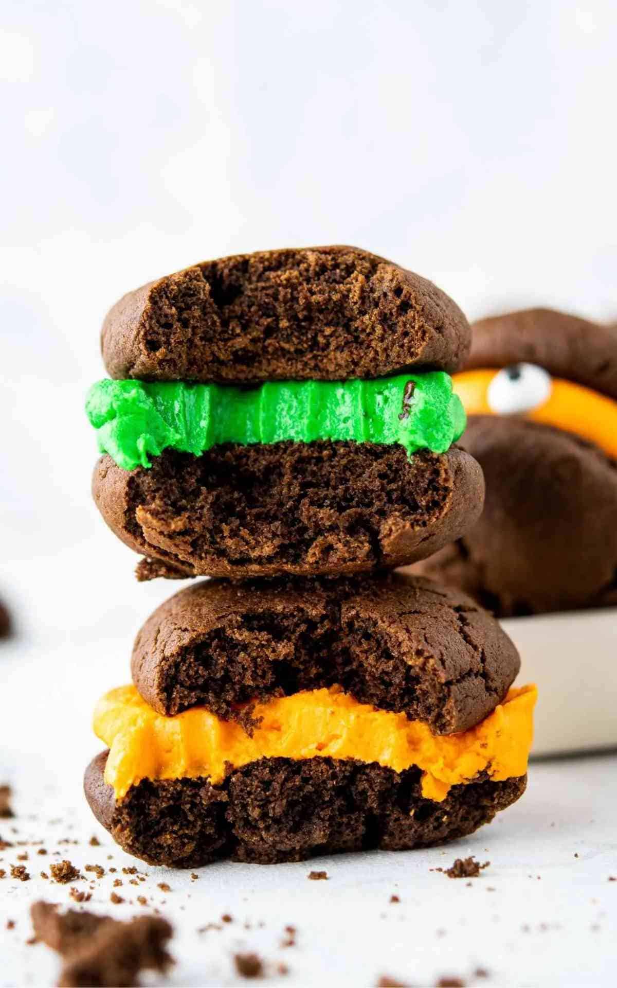 Bites taken out of chocolate sandwich cookies with green and orange filling.