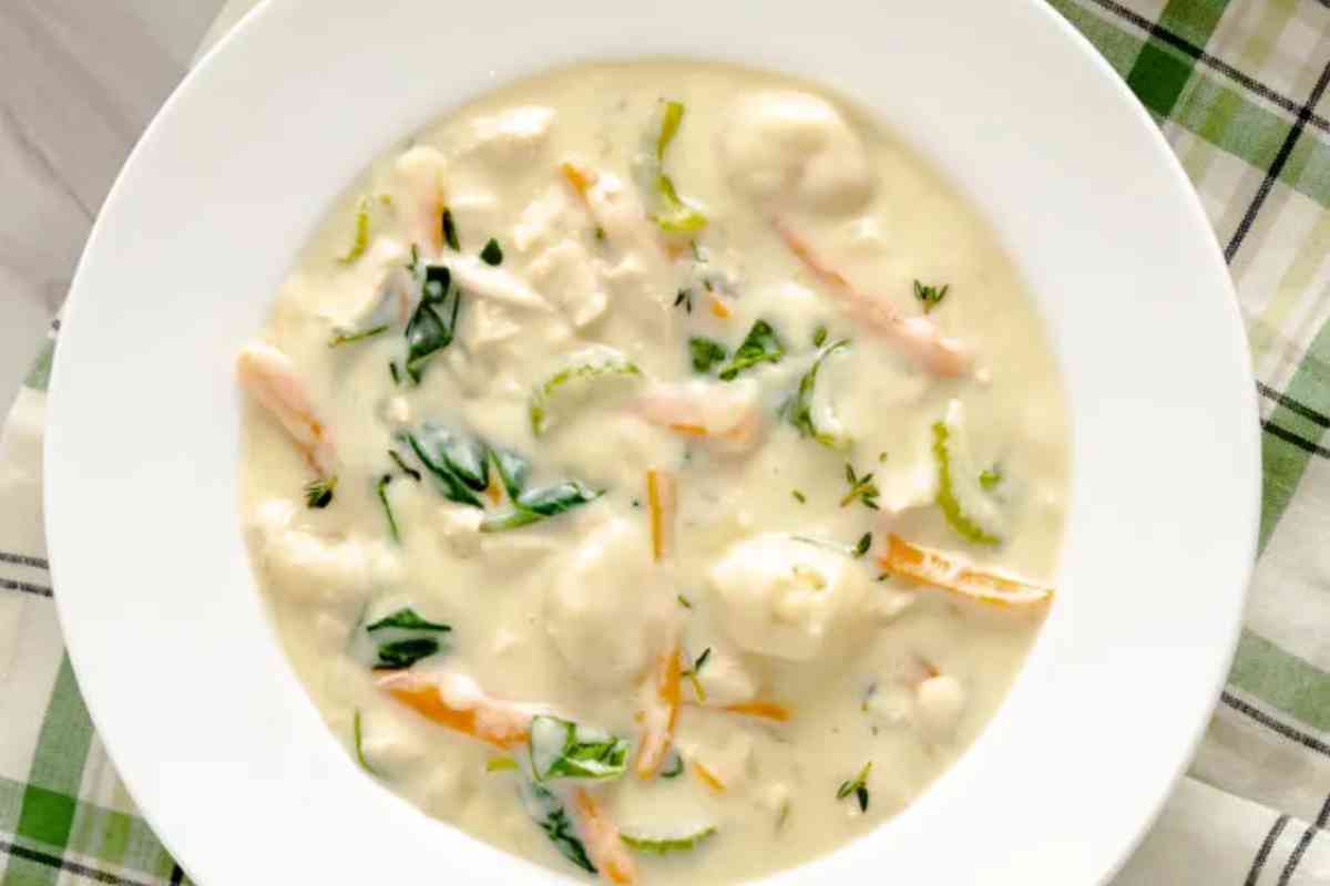 A wide rimmed bowl of creamy chicken and gnocchi soup copycat.