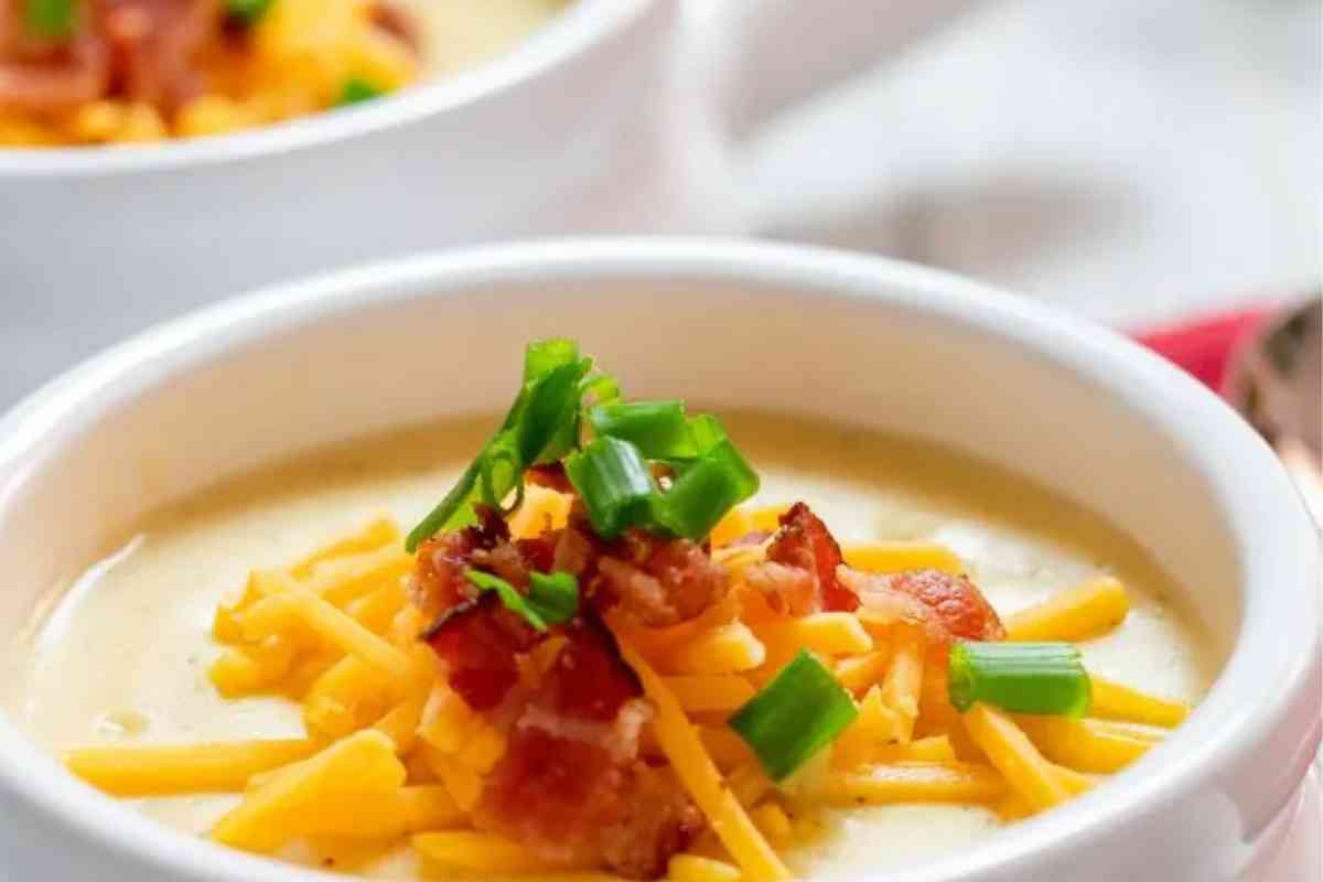 Instant Pot Outback Steakhouse Potato Soup copycat recipe in a white bowl with toppings.