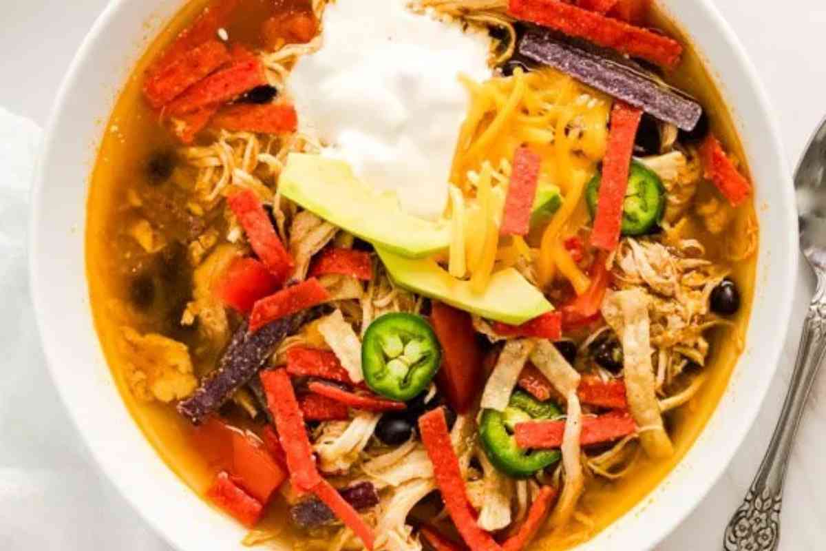 Instant Pot Southwestern Chicken Fajita Soup with tortilla strips and sour cream.