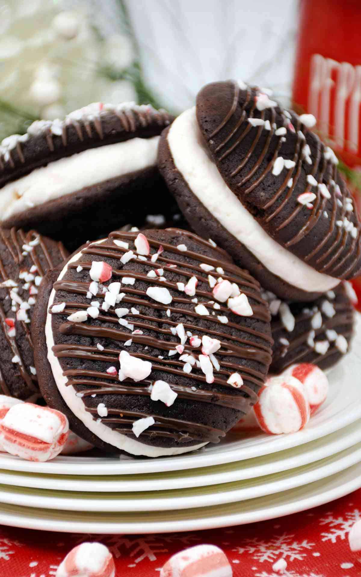 A stack of plates with whoopie pies with candy canes stacked on top.