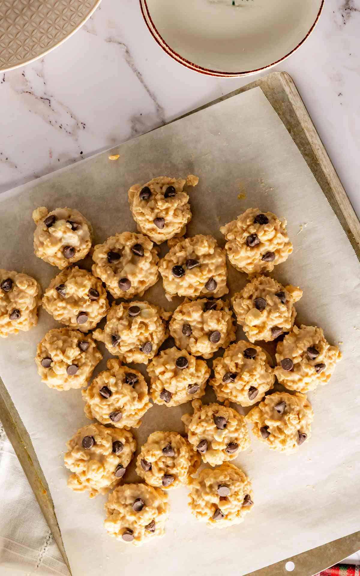 No bake avalanche cookies firming up on parchment paper.