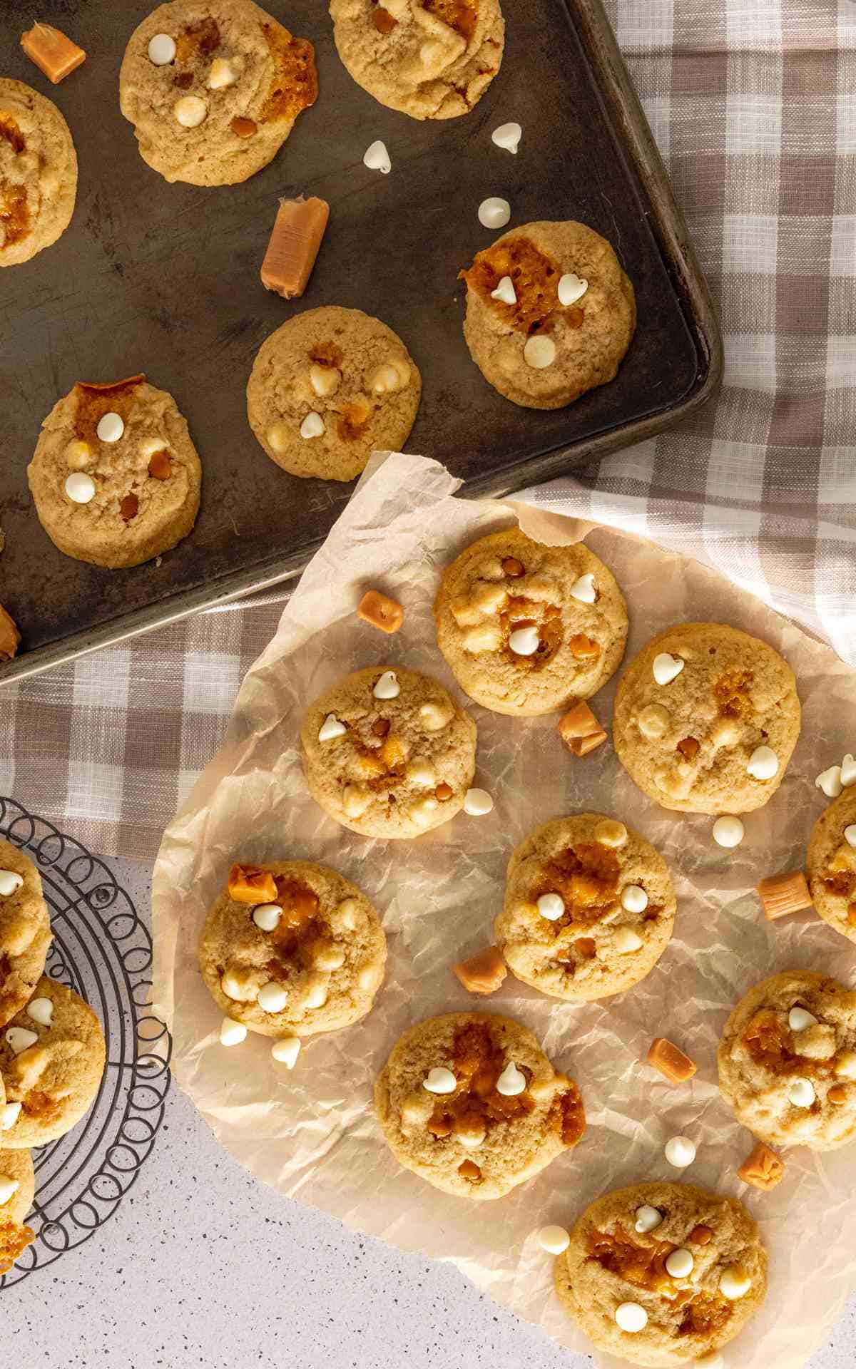 Overhead view of cooling salted caramel cookies with white chocolate chips.