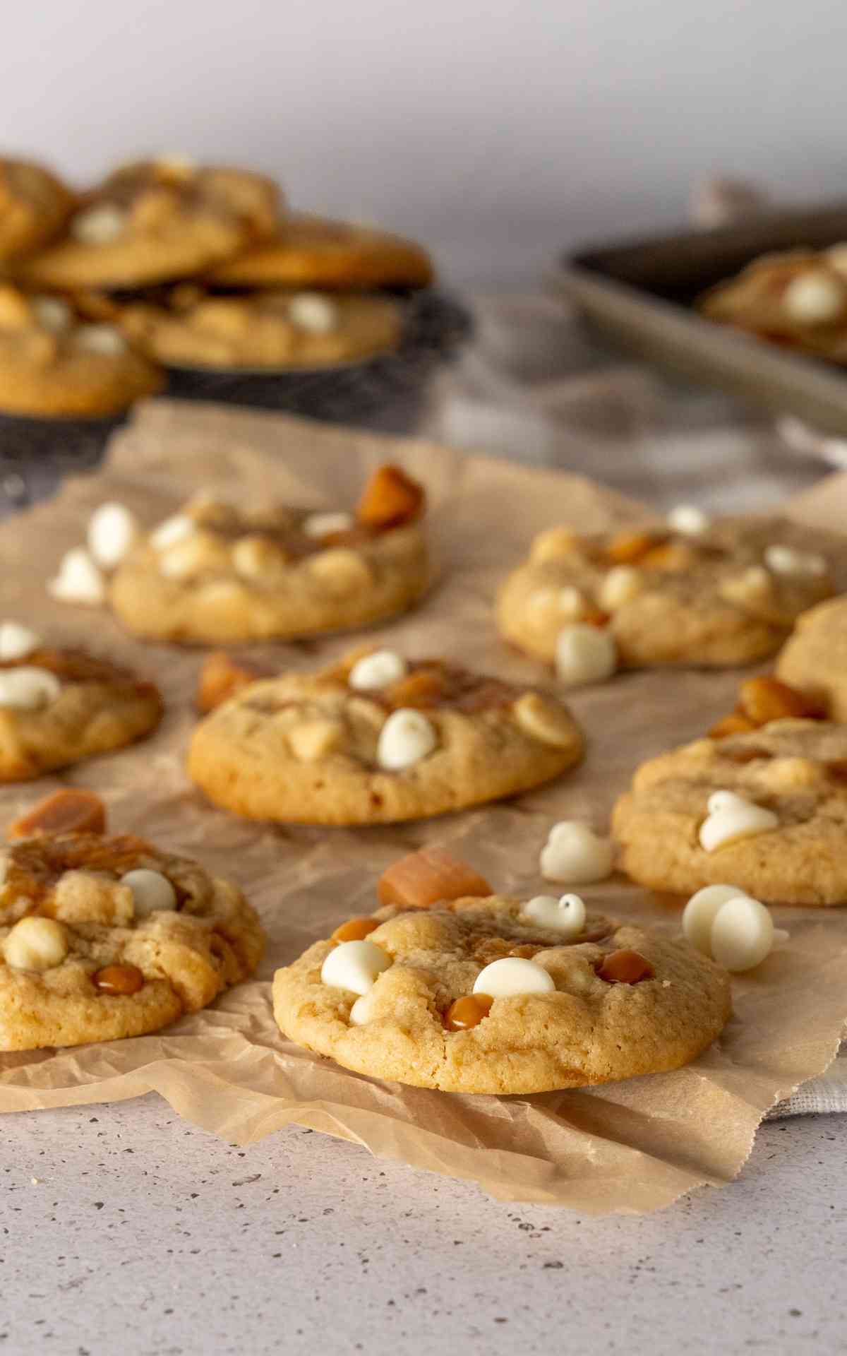 Unbleached parchment paper with cooling salted caramel cookies.