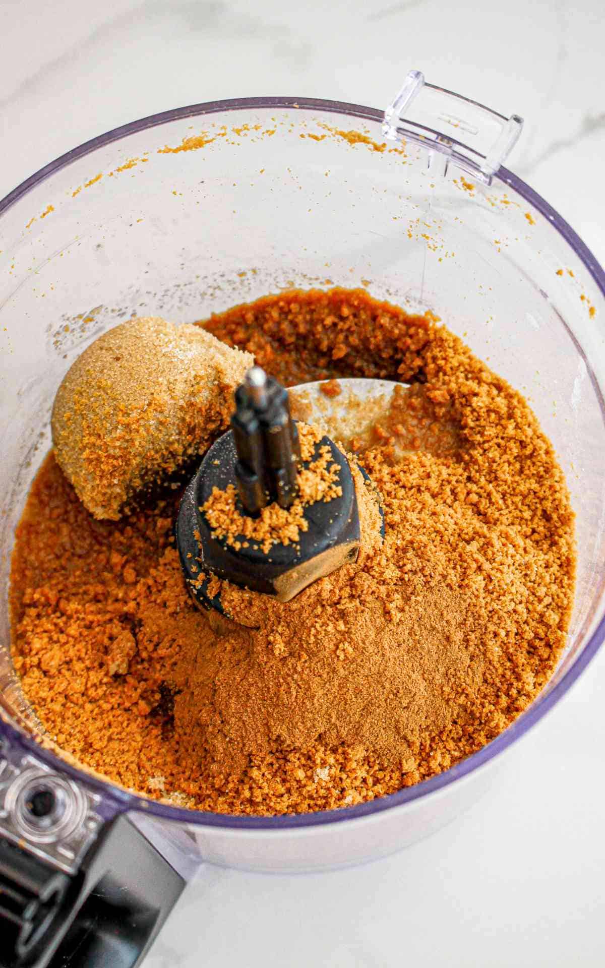 Biscoff cookies being ground in food processor.