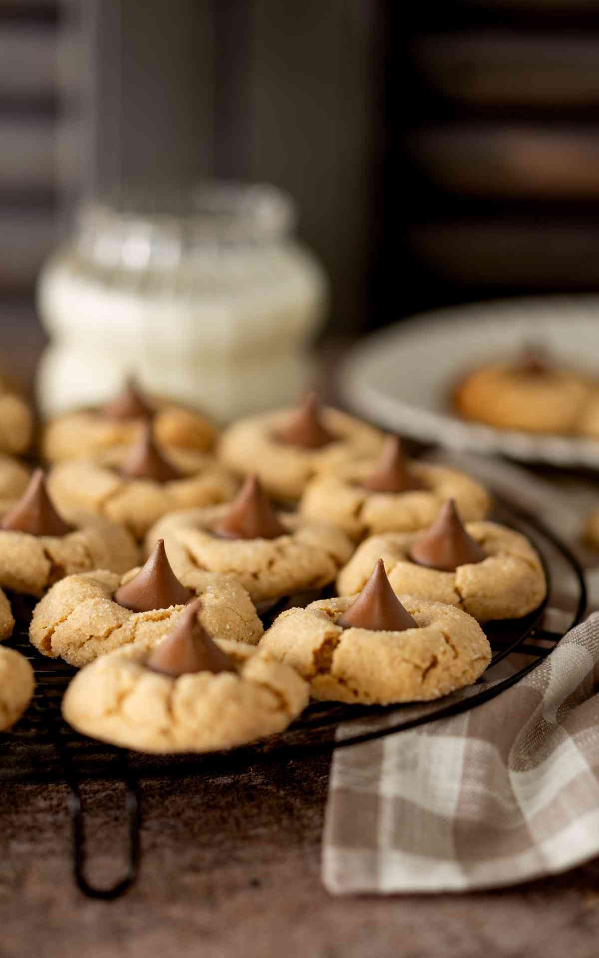Peanut butter kiss cookies cooling on a wire rack.