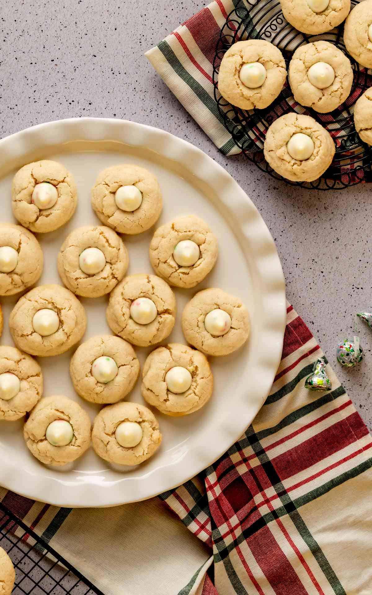 Overhead photo of sugar cookies with kisses and Christmas linens.