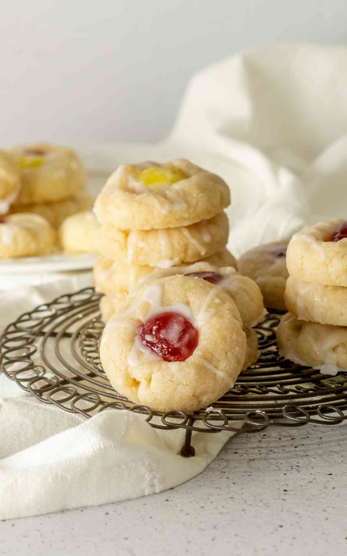 A stack of lemon and raspberry jam shortbread cookies.