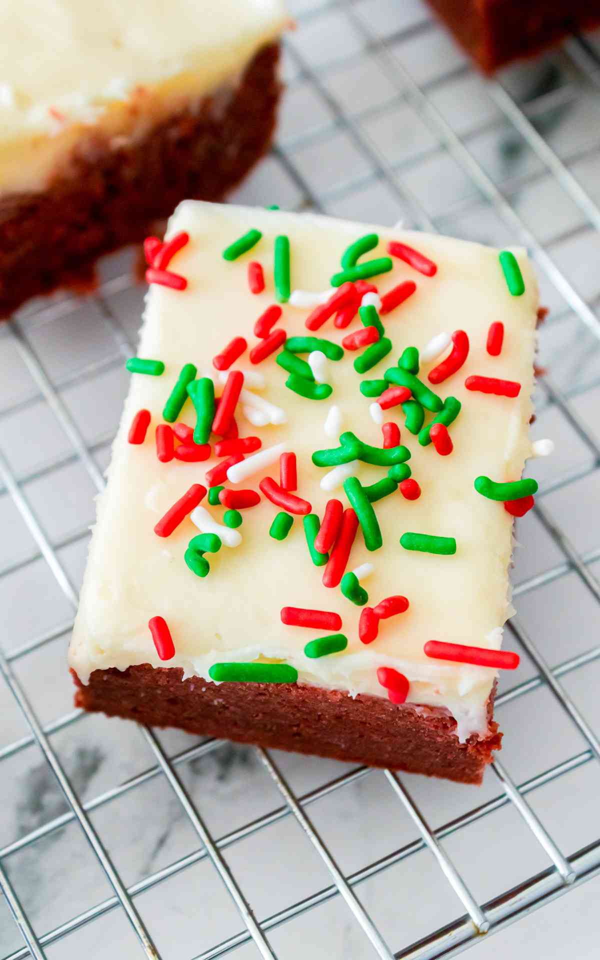 Christmas red velvet bars with festive sprinkles.
