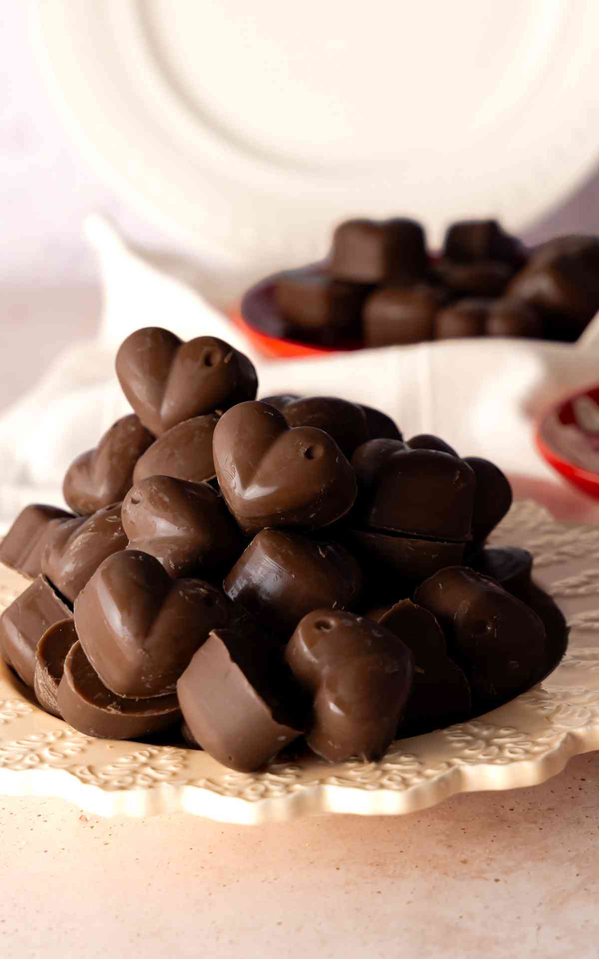Heart shaped peanut butter meltaways on a white decorative plate.