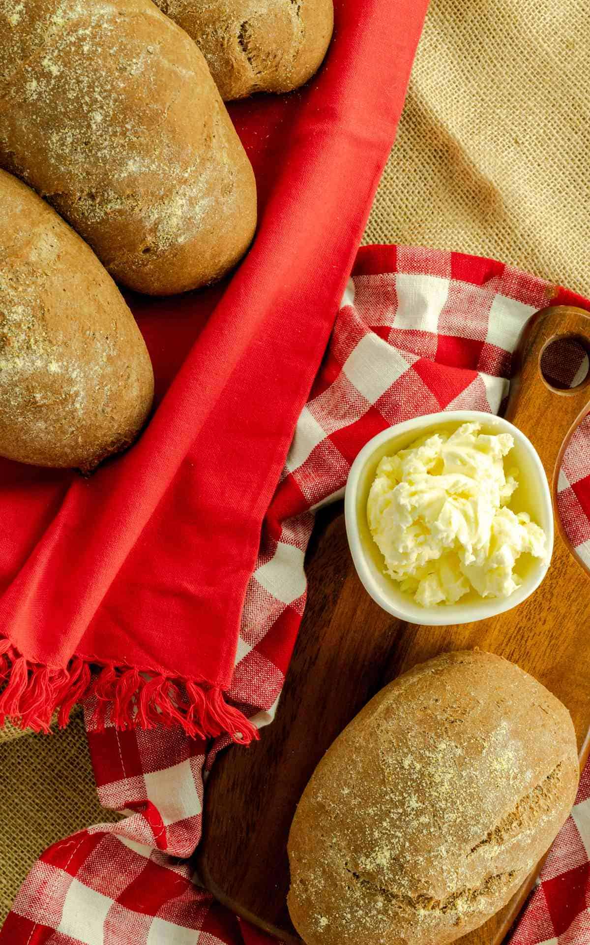 Birdseye view of honey wheat bread on red linen napkins.