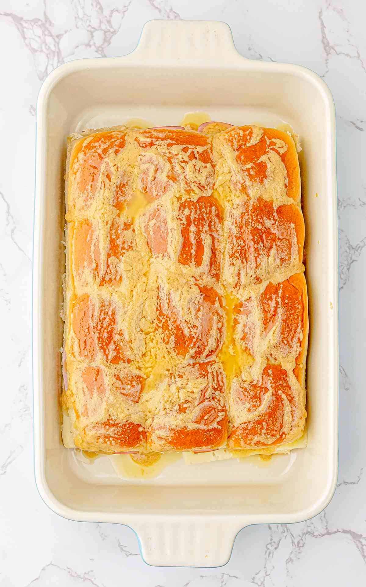 Butter and garlic mixture on top of the buns before baking.