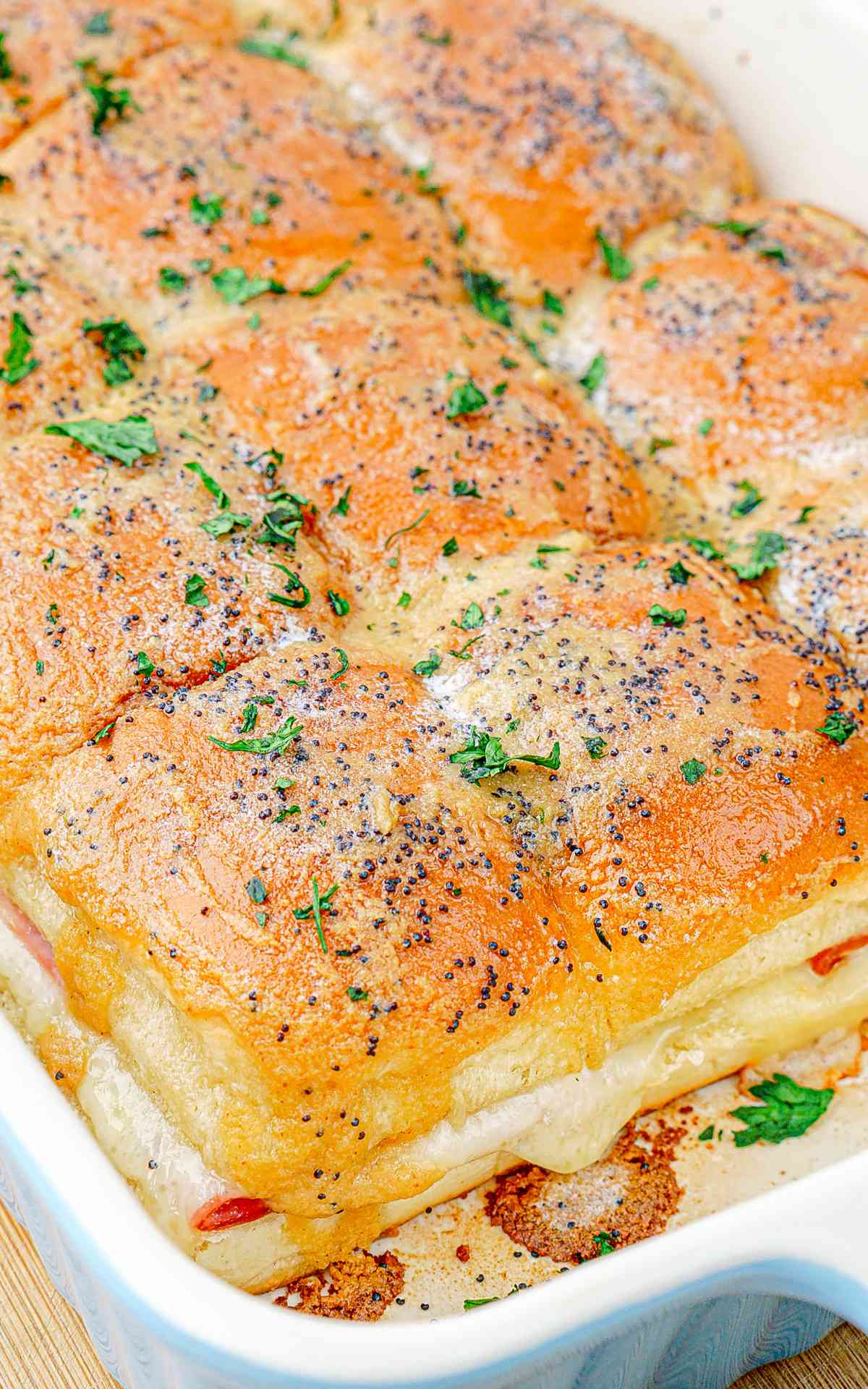 Freshly baked Hawaiian sliders with ham and swiss cheese.