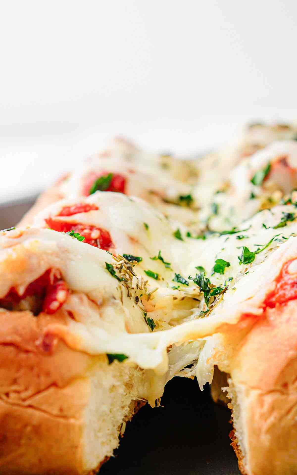 Pull apart meatball sliders with melted cheese.