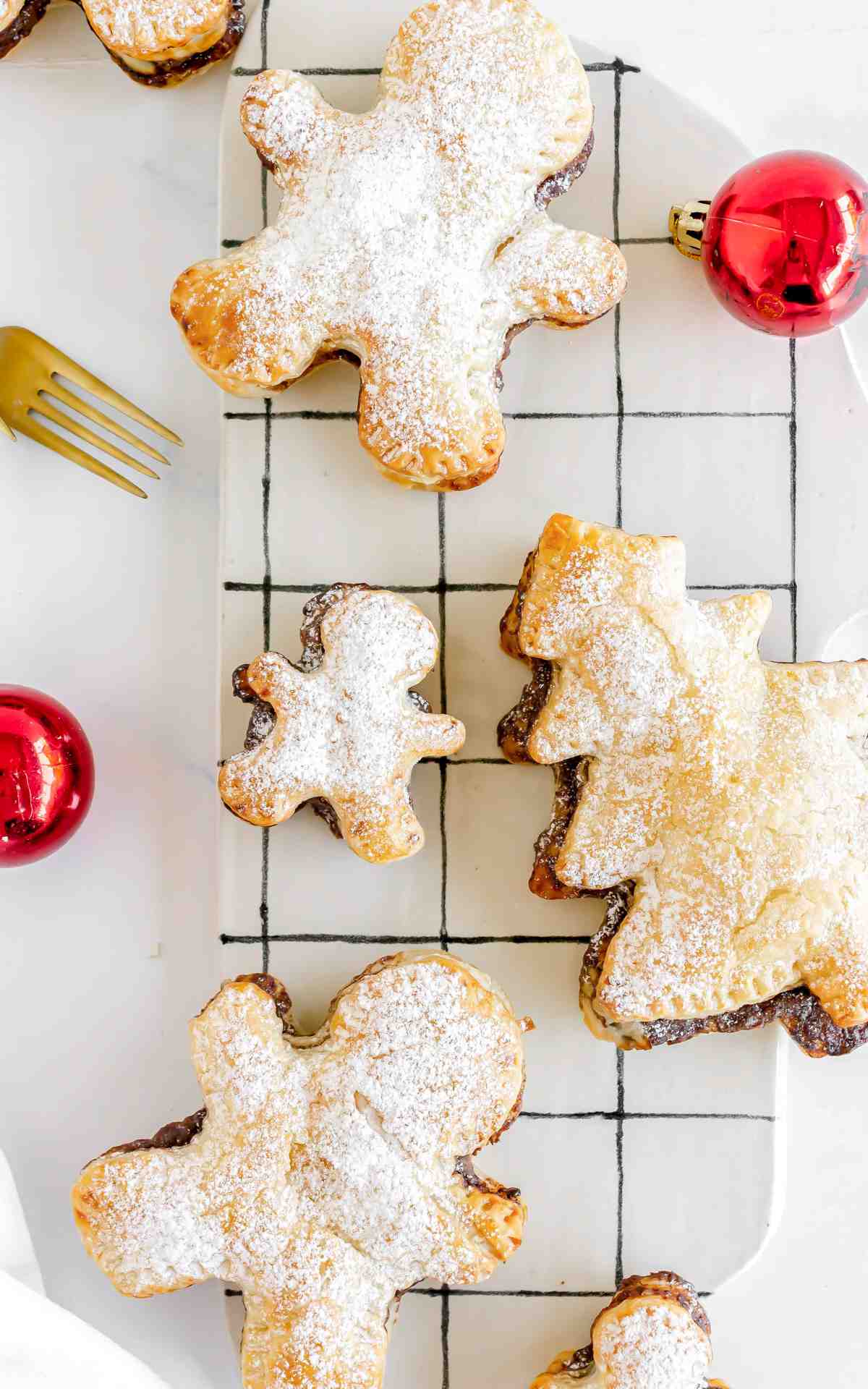 Baked Nutella puff pastries shaped like Christmas trees and gingerbread men.