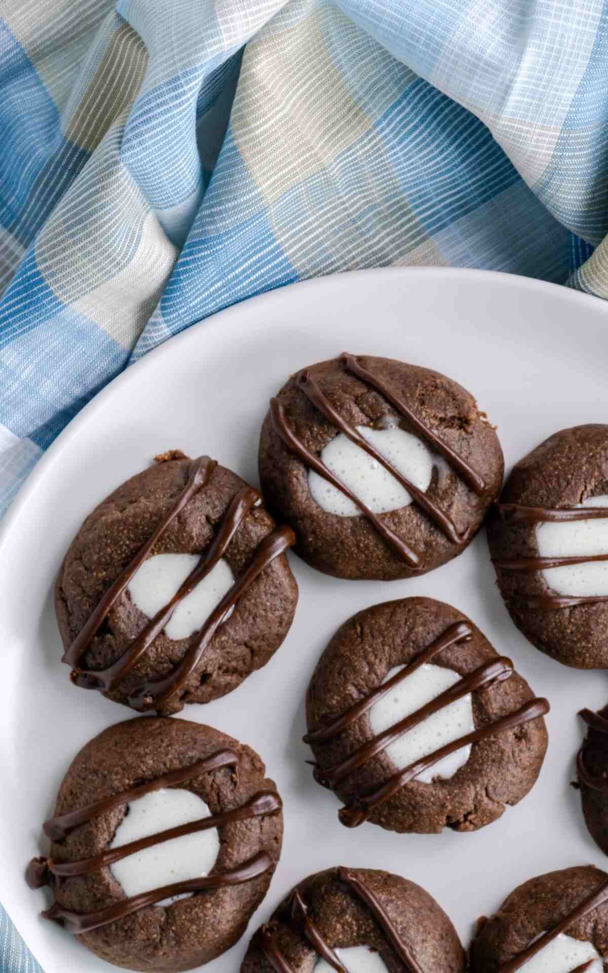A plate of marshmallow cream filled Chocolate Thumbprint Cookies.