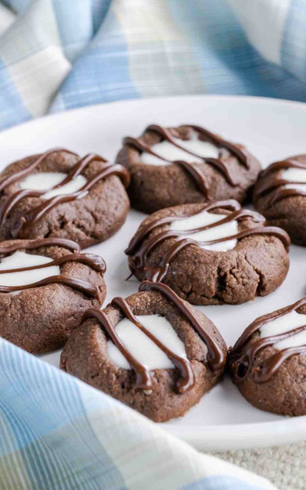Chocolate Thumbprint Cookies with Marshmallow Cream Filling with chocolate drizzle.