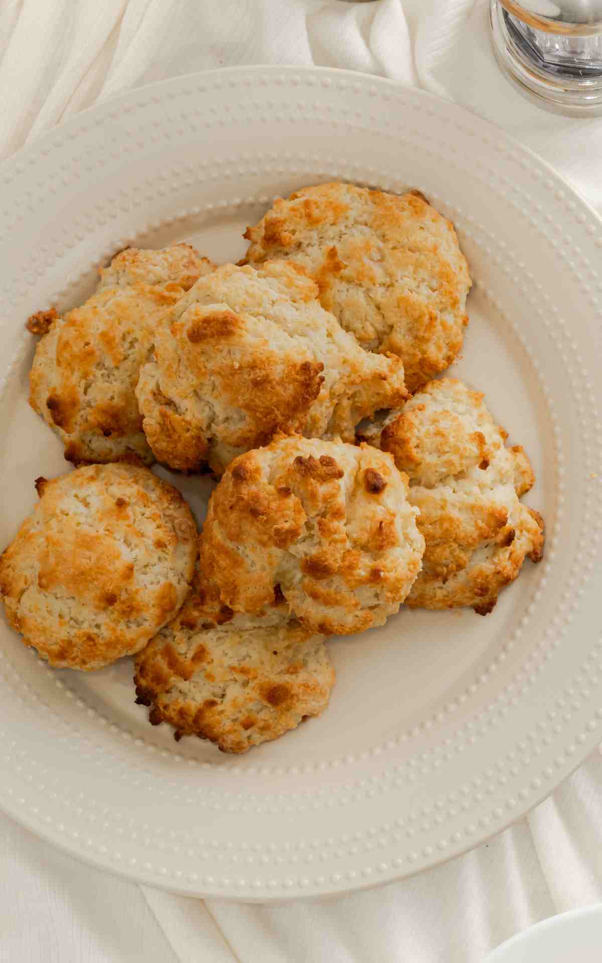 Overhead picture of a plate of drop style buttermilk biscuits.