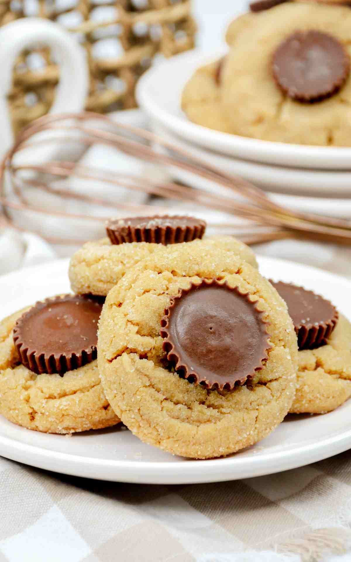A plate of peanut butter cookies with Reese's mini chocolates.
