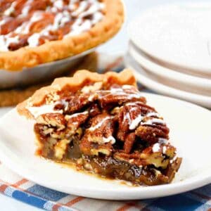 Bourbon Pecan Pie slice on a saucer featured image.