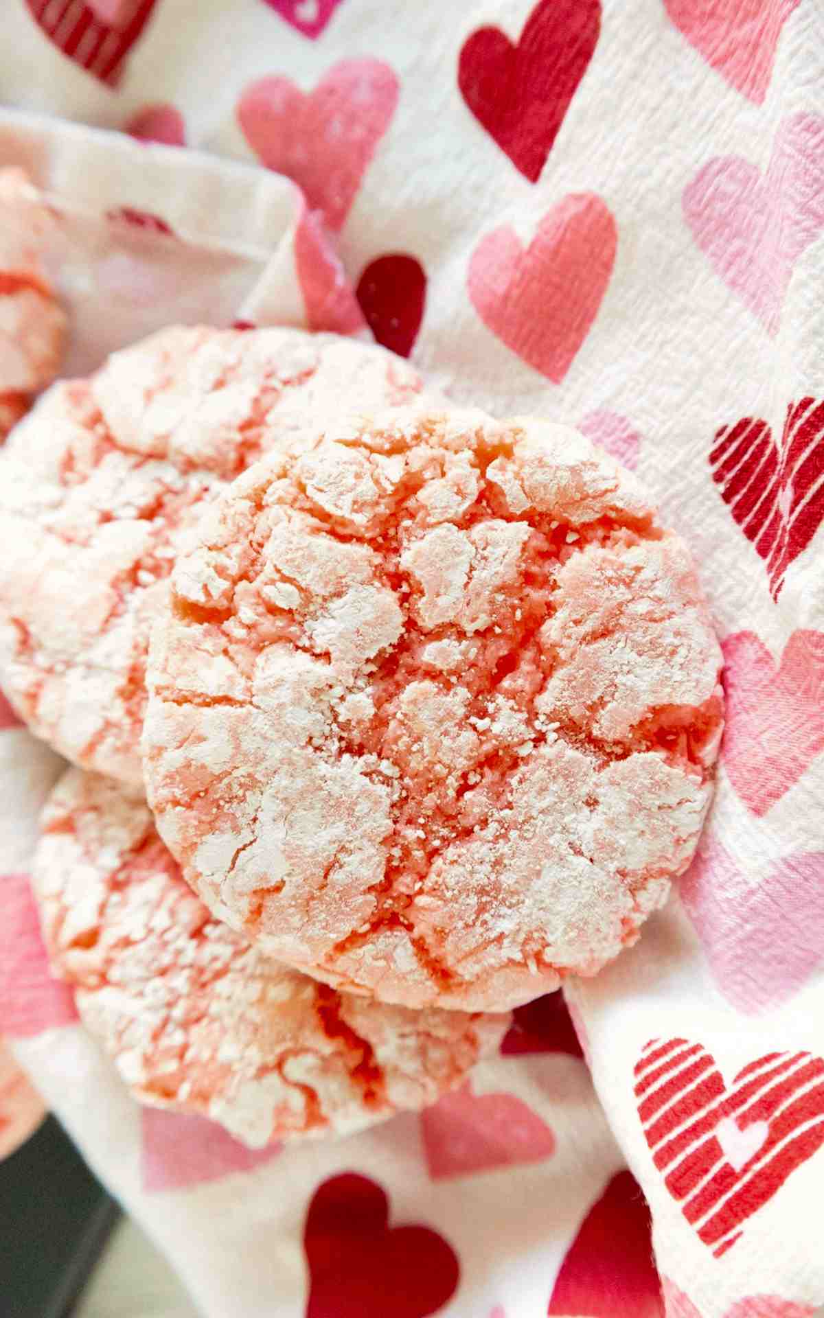 Crinkled cake mix cookies stacked on decorative napkin.