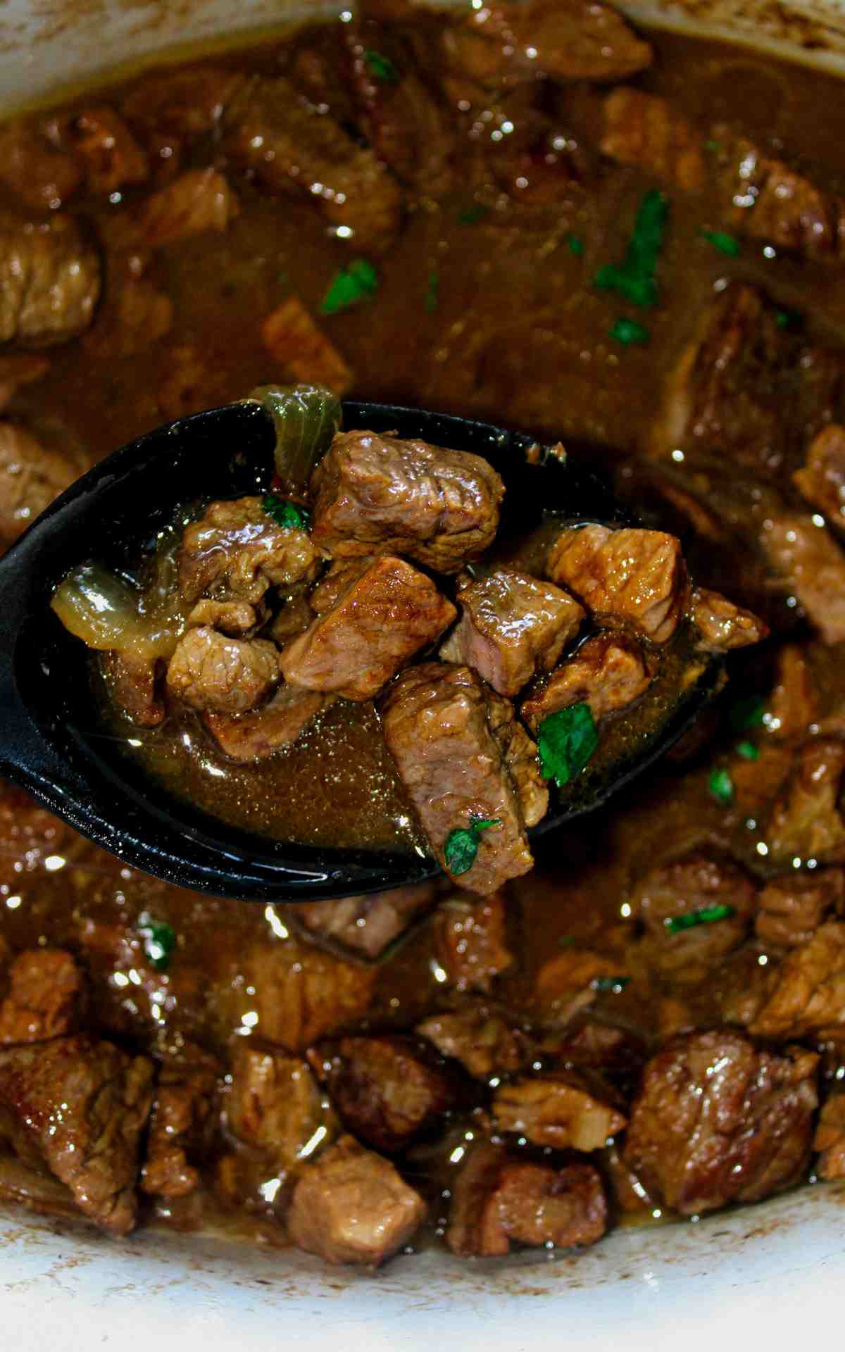Slow Cooker Beef Tips and Onion Gravy in a crockpot.