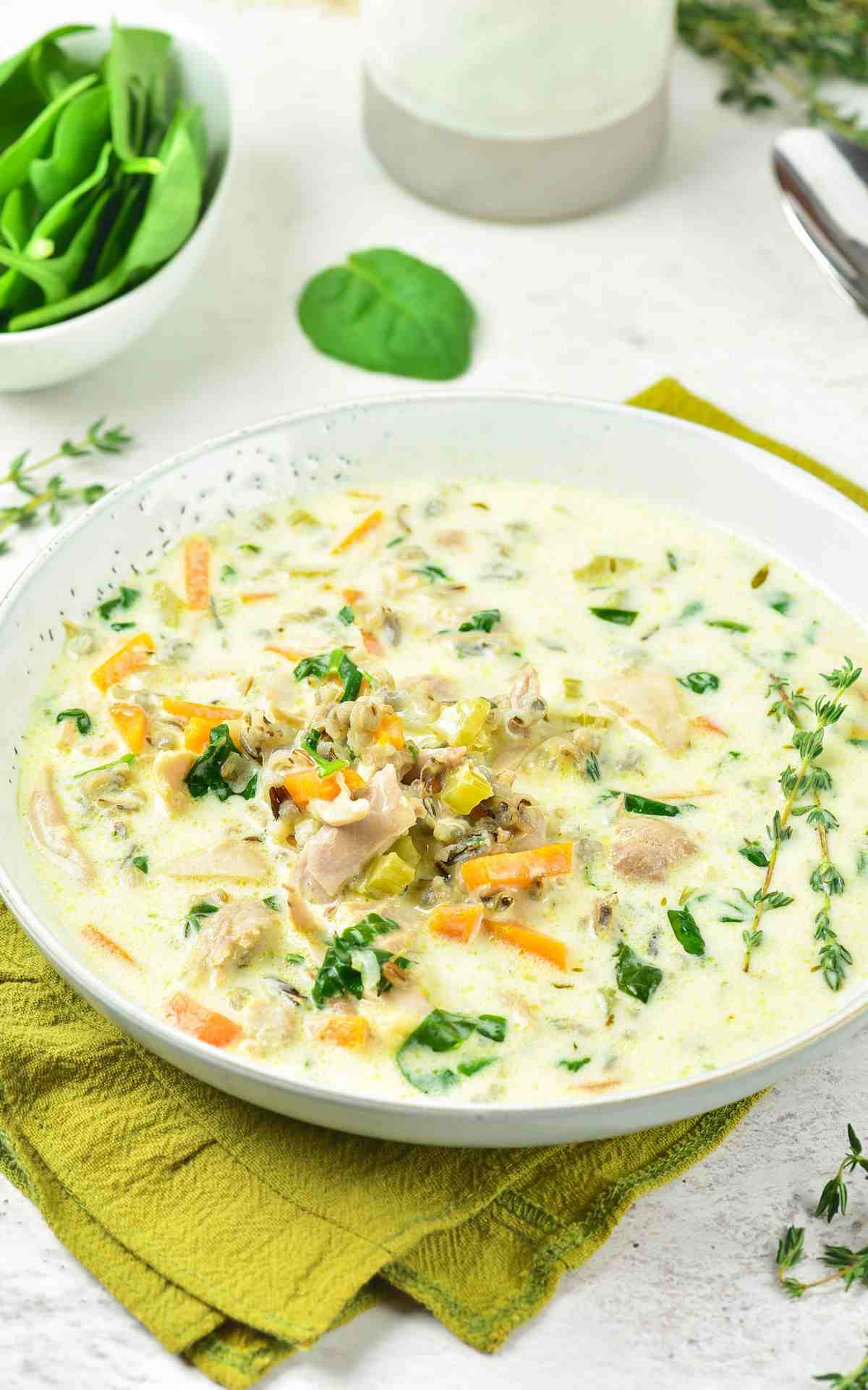 Chicken Wild Rice Soup in a bowl with fresh herbs.