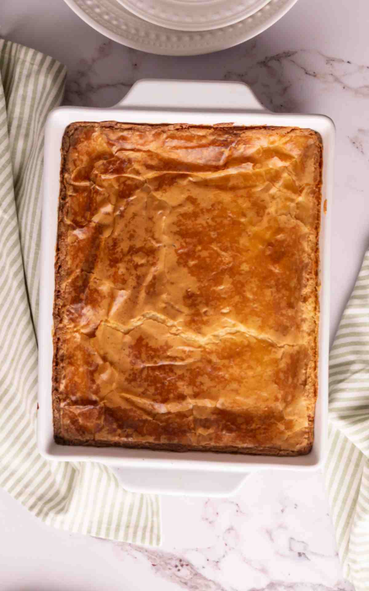 Freshly baked gooey butter cake with a nice crust on top of the cake.