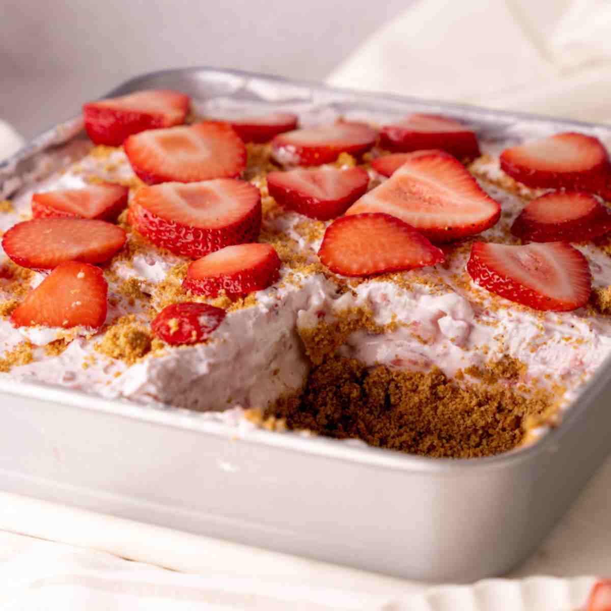 No Bake Strawberry Dessert in a pan featured image.