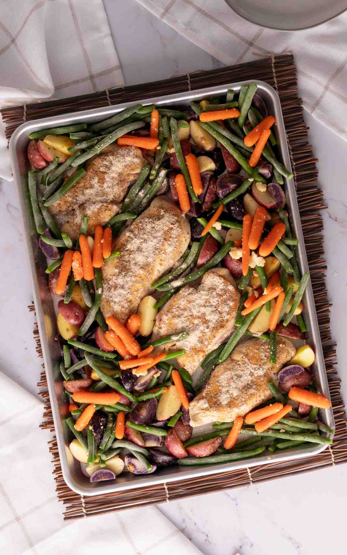 Sheet Pan meal prep for chicken and veggies before being baked.
