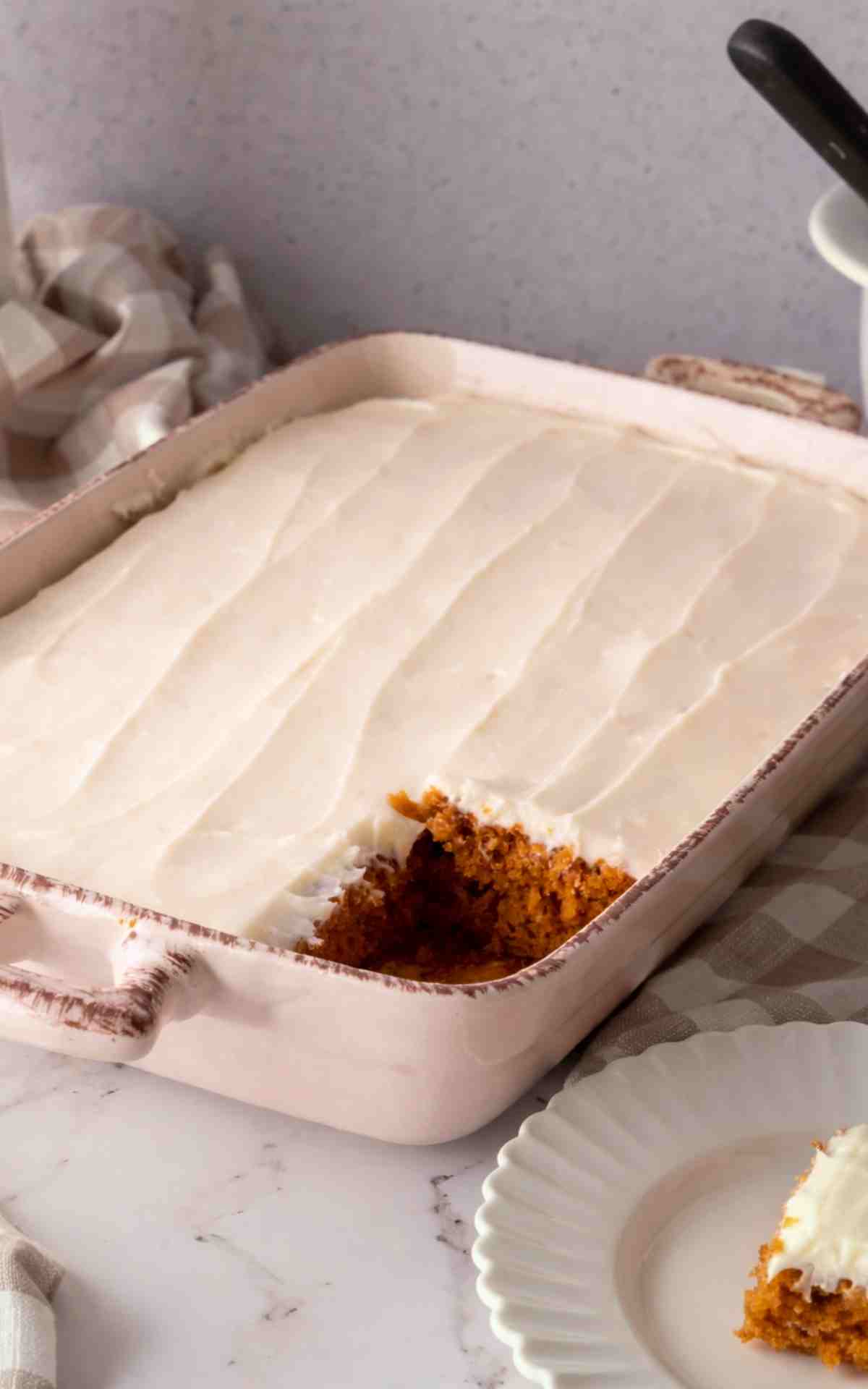 Tomato Soup Cake in a rectangle dish with a slice taken out of it.