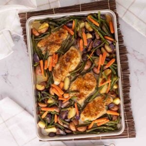 Top view chicken and vegetables sheet pan meal.